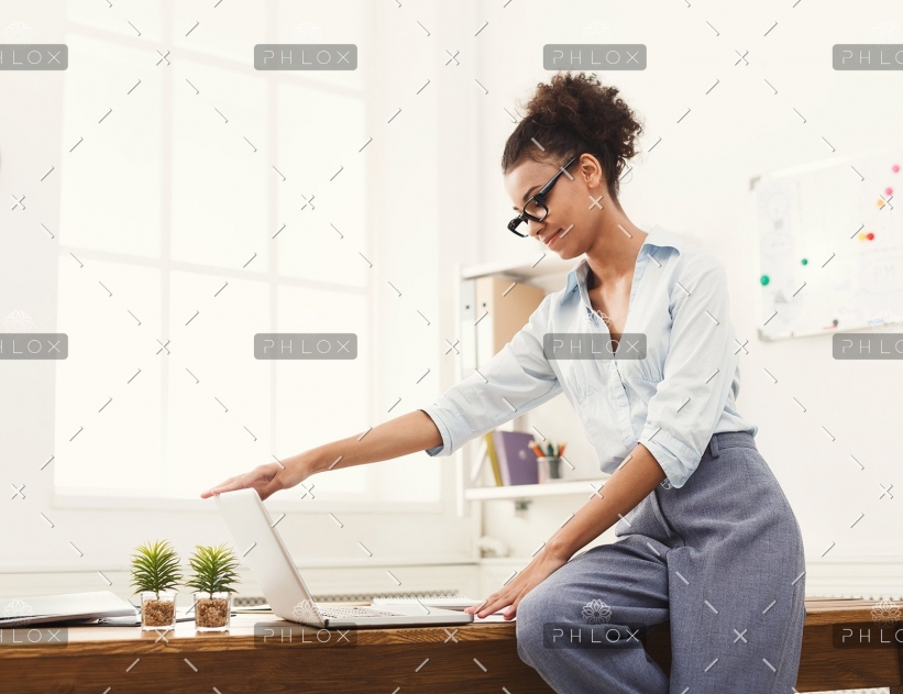 demo-attachment-505-business-woman-opening-laptop-at-office-PU4ZAGW